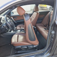 the interior of a car with brown leather seats